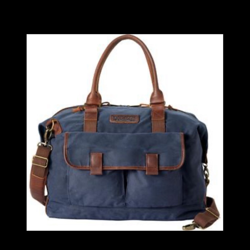 Duluth Trading Co Oil Cloth Weekender Bag with Brown Leather handles and trim.